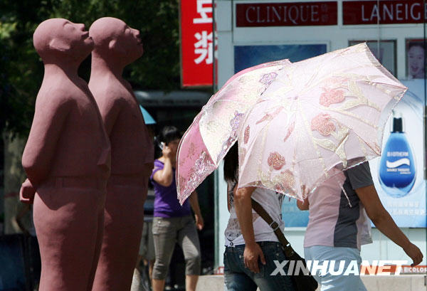 6月24日，市民撑伞走过洛阳街头。
